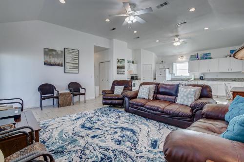 a living room with leather couches and a rug at Molly's Place home in Crystal Beach