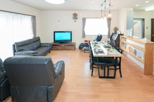 a living room with a couch and a table at 民泊 丘の上 in Seto