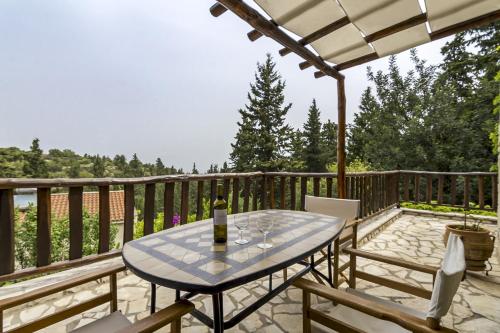a patio with a table and chairs on a deck at Manoli's House in Douliana