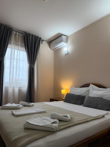 a bedroom with a large bed with two towels on it at Hotel "VIR" in Velika Plana