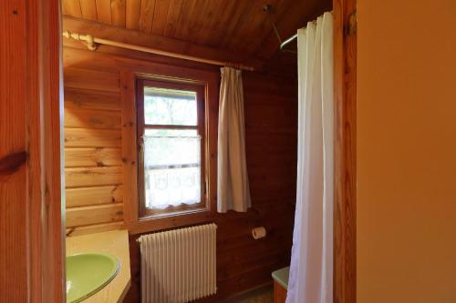 a bathroom with a green sink and a window at Ferienhaus Neckar 46 in Hayingen