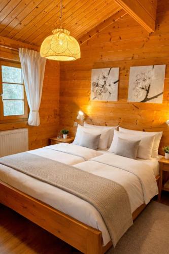 a bedroom with a large bed in a wooden wall at Ferienhaus Tauber 29 in Hayingen