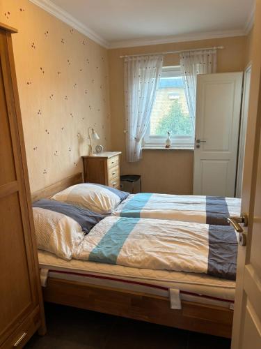 a bed in a bedroom with a window and a bed sidx sidx sidx at Leuchtturm 1 in Fehmarn