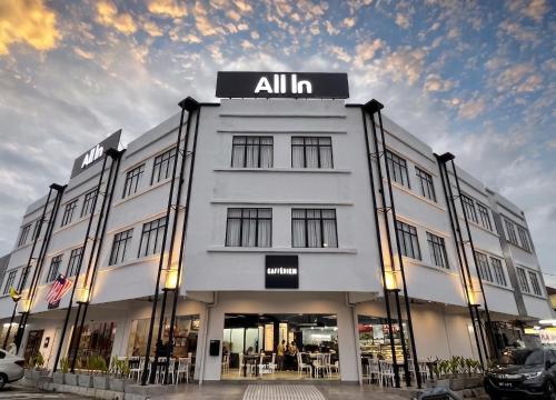 a white building with an all in sign on it at ALL IN HOTEL in Kangar