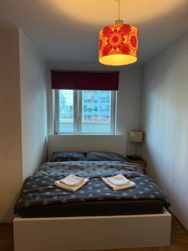 a bedroom with a bed with two towels on it at Łucka 15 Sweet Home in Warsaw