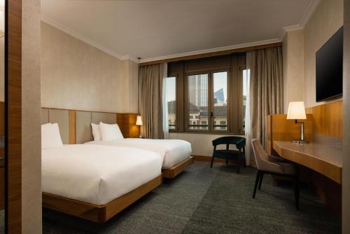 a hotel room with a bed and a desk at Hilton Milan in Milan