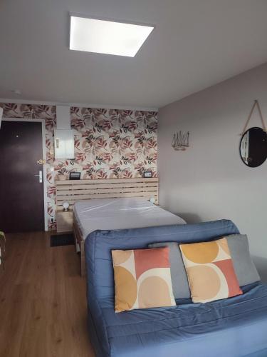 a bedroom with a blue bed in a room at Studio "L'authentique" vue sur la Baie d'Authie in Berck-sur-Mer