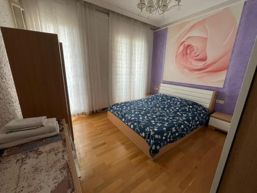 a bedroom with a bed and a painting on the wall at Premium Airport Residence 2 in Baku