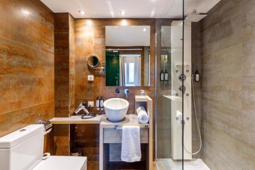ein Badezimmer mit Dusche und Waschbecken in der Unterkunft Petit Palace Tamarises in Getxo