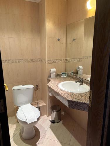 a bathroom with a toilet and a sink at Motel Hanat in Saints Constantine and Helena