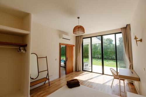 a bedroom with a bed and a large window at Phangan Sky Villa in Ban Madua Wan