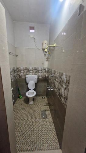 a bathroom with a white toilet in a room at Yara Homes in Cochin