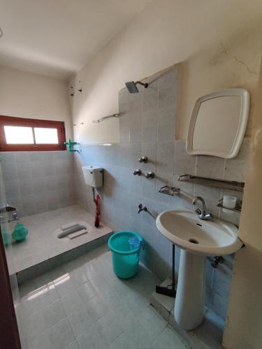 a bathroom with a sink and a shower and a tub at Indus Motel in Skardu