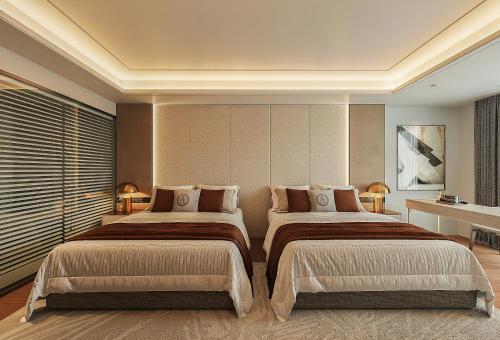 a bedroom with two beds in a room at Splendid Star Suite Hotel in Hanoi