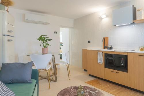 a kitchen and living room with a couch and a table at Pini al Mare in Monterosso al Mare