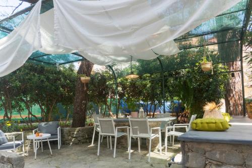 a patio with a table and chairs under a tent at Pini al Mare in Monterosso al Mare
