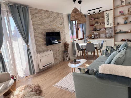 a living room with a couch and a dining room at Boutique apartment Bansko Bell Tower in Bansko