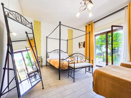 a bedroom with a canopy bed and a balcony at Mamma Lucia in Sorrento