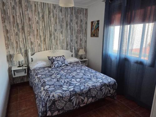 a bedroom with a bed and a window at Casa Cielito Lindo in Las Eras