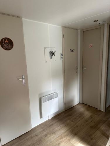 an empty room with white walls and wooden floors at Camping L Eden Road in Castellane