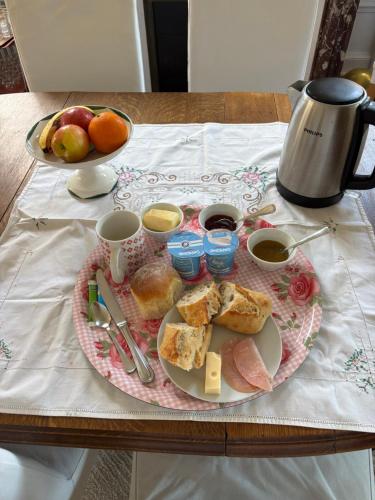 a table with a tray of breakfast food on it at Maison Dentelle in Caudry