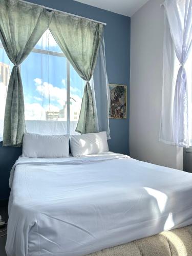 a large white bed in a bedroom with a window at Apartment in joburg in Johannesburg