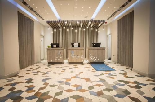 a large room with a lobby with two counters at DoubleTree by Hilton Coventry Building Society Arena in Coventry