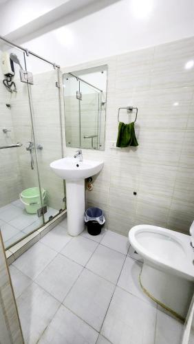 a bathroom with a sink and a toilet at Bohol Ramyer Villa in Totolan