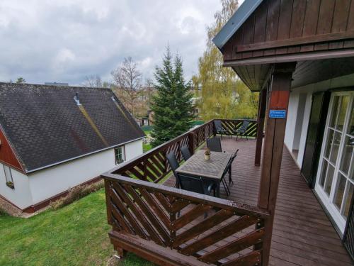a wooden deck with a picnic table on it at Chata Větrník u Černého dolu v Krkonoších in Lauterwasser