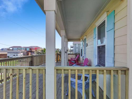 a balcony with a table and chairs on a house at Casa Carmen home in Crystal Beach