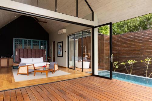 an open deck with a bedroom and a pool at Andriyala in Haputale