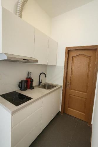 a small kitchen with a sink and a door at Midi station in Brussels