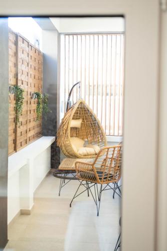 a room with two chairs and a hammock at Santa Rosa Apartments in Kalamata