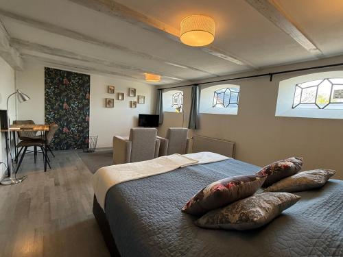 a bedroom with a bed with pillows on it at Bed and Breakfast de Salix in Hitzum