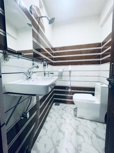 a bathroom with a sink and a toilet at Pasne Aajako Hotel in Bandipur