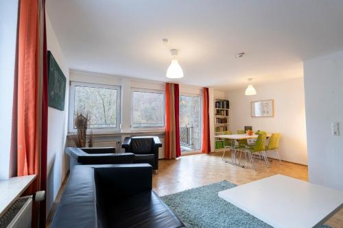 a living room with a couch and a table at Jugendherberge Bad Urach in Bad Urach