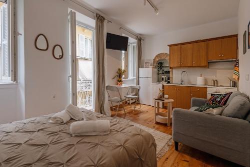 a living room with a bed and a kitchen at Tonella Studio in Corfu