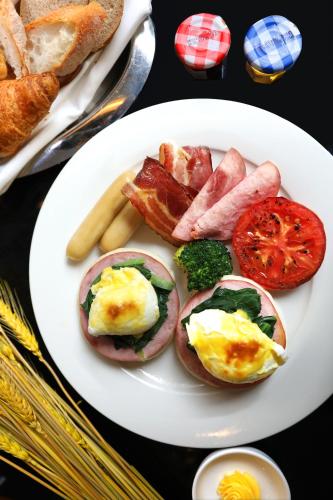 a plate of breakfast food with eggs and bacon at JW Marriott Hotel Chongqing in Chongqing