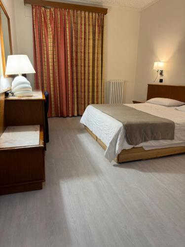 a hotel room with two beds and a window at Hotel Giardino in Arona