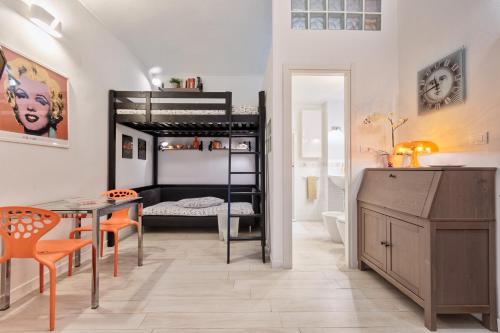 a bedroom with a bunk bed and a table and a desk at LittleAndCosy in Turin