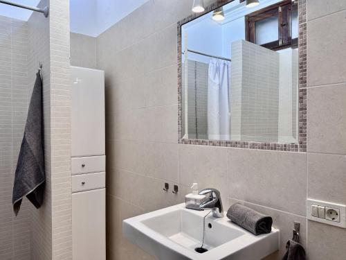 a bathroom with a sink and a mirror at Bungalow Atlantic View in Maspalomas