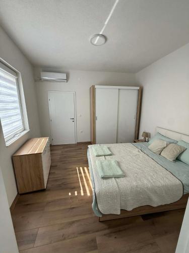 a bedroom with a bed and a wooden floor at Central Lux Stay Prilep in Prilep