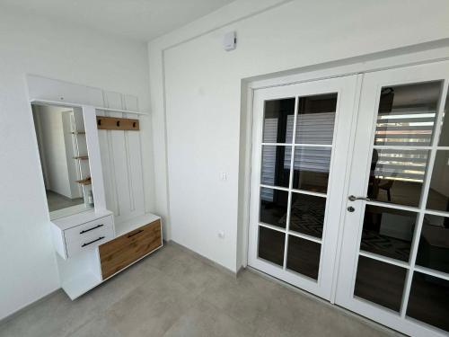 a bathroom with white walls and a large window at Central Lux Stay Prilep in Prilep