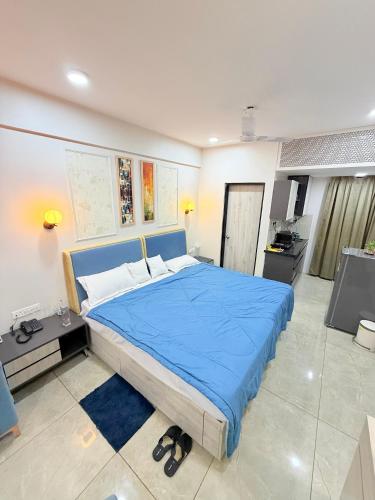 a bedroom with a large blue bed in a room at The Sakshi suite - Luxury Saty with Premium Comfort in Jaipur
