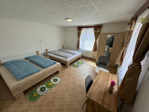 a living room with a bed and a table at Apartmány 107 in Olešnice v Orlických horách