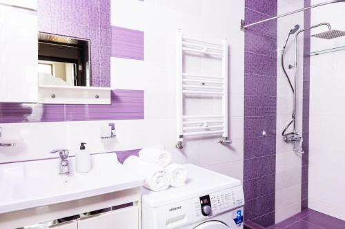 a bathroom with a sink and a washing machine at City View 2BR With Balcony, Steps To Cascade And North Avenue l New Building in Yerevan