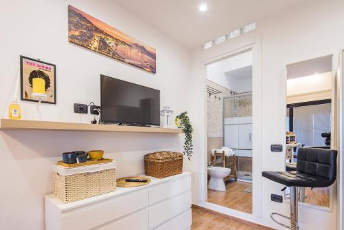 a living room with a television and a chair at Way to Coast in Sant'Egidio del Monte Albino