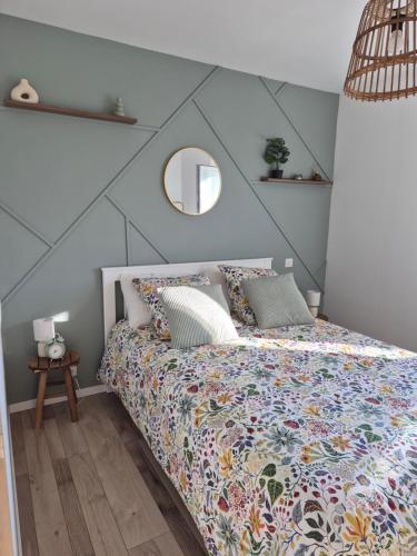 a bedroom with a bed and a mirror on the wall at chez mamy in Reguisheim