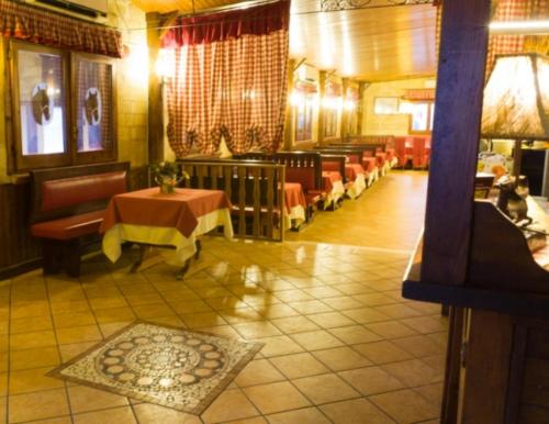 a restaurant with tables and chairs in a room at Hotel Tenuta San Francesco in Barletta