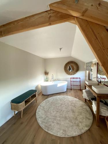 a bathroom with a bath tub and a sink at La Maison des Champs in Ciney